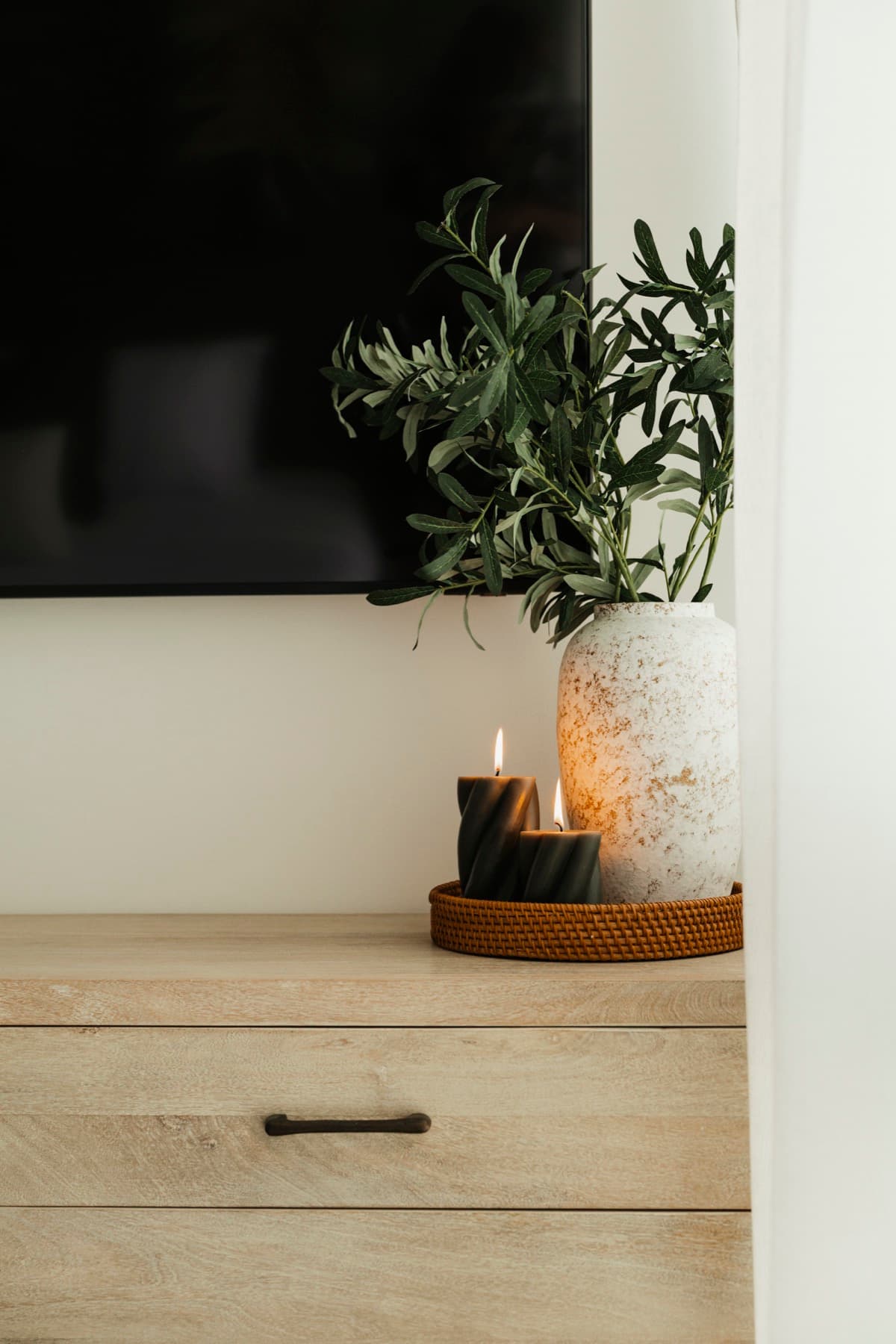 Ceiba at 25 bedroom dresser with greenery and candles