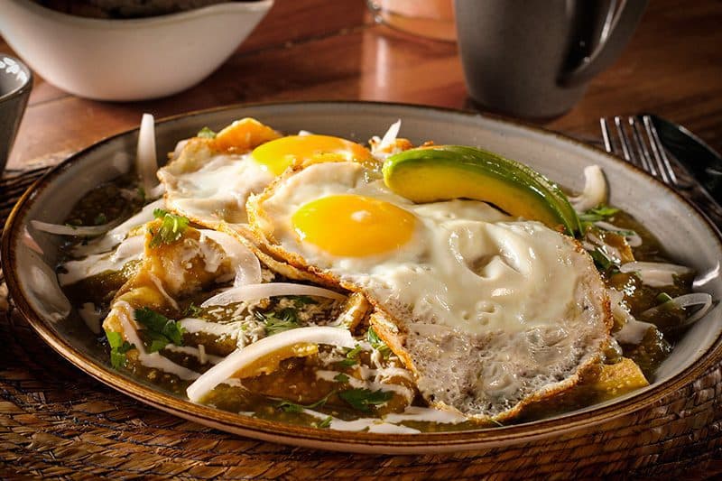 Chilaquiles verdes with fried eggs and avocado at Amate 38 brunch in Playa del Carmen