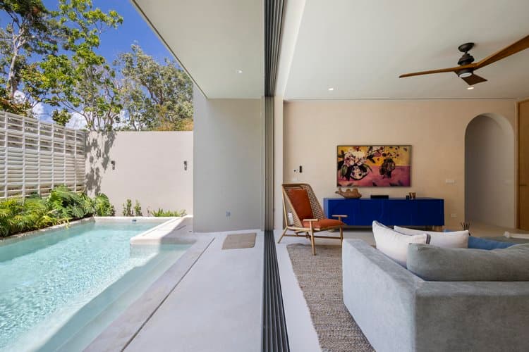 Indoor-outdoor living with plunge pool and tropical planting at Aflora Tulum