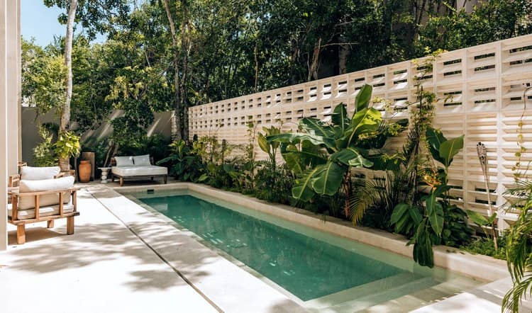 Lap pool and patio of a Tulum residence under active operations