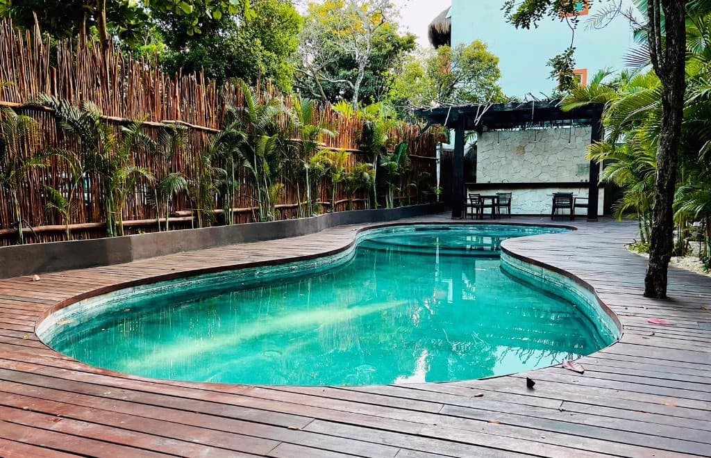 Communal pool area at Artia Condos with tropical landscaping